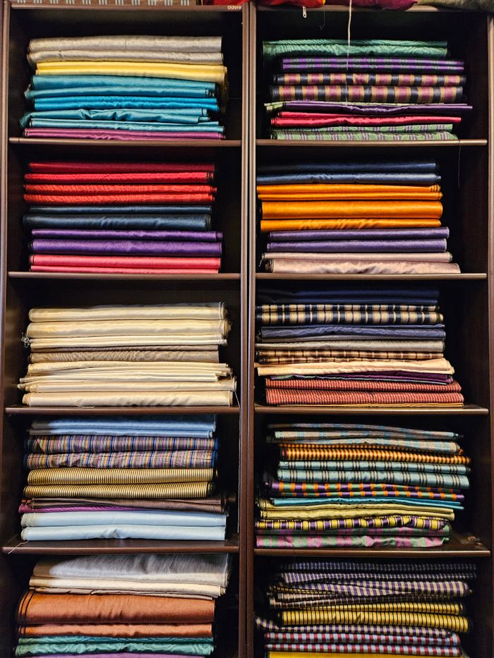 Vibrant textured fabrics in a vertical array showcasing diverse colors and patterns.